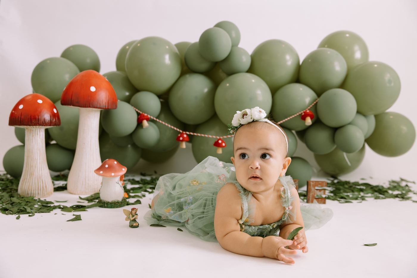 Baby girl in a flower crown on the woodland mushroom set at a spring mini session in Southwest Florida