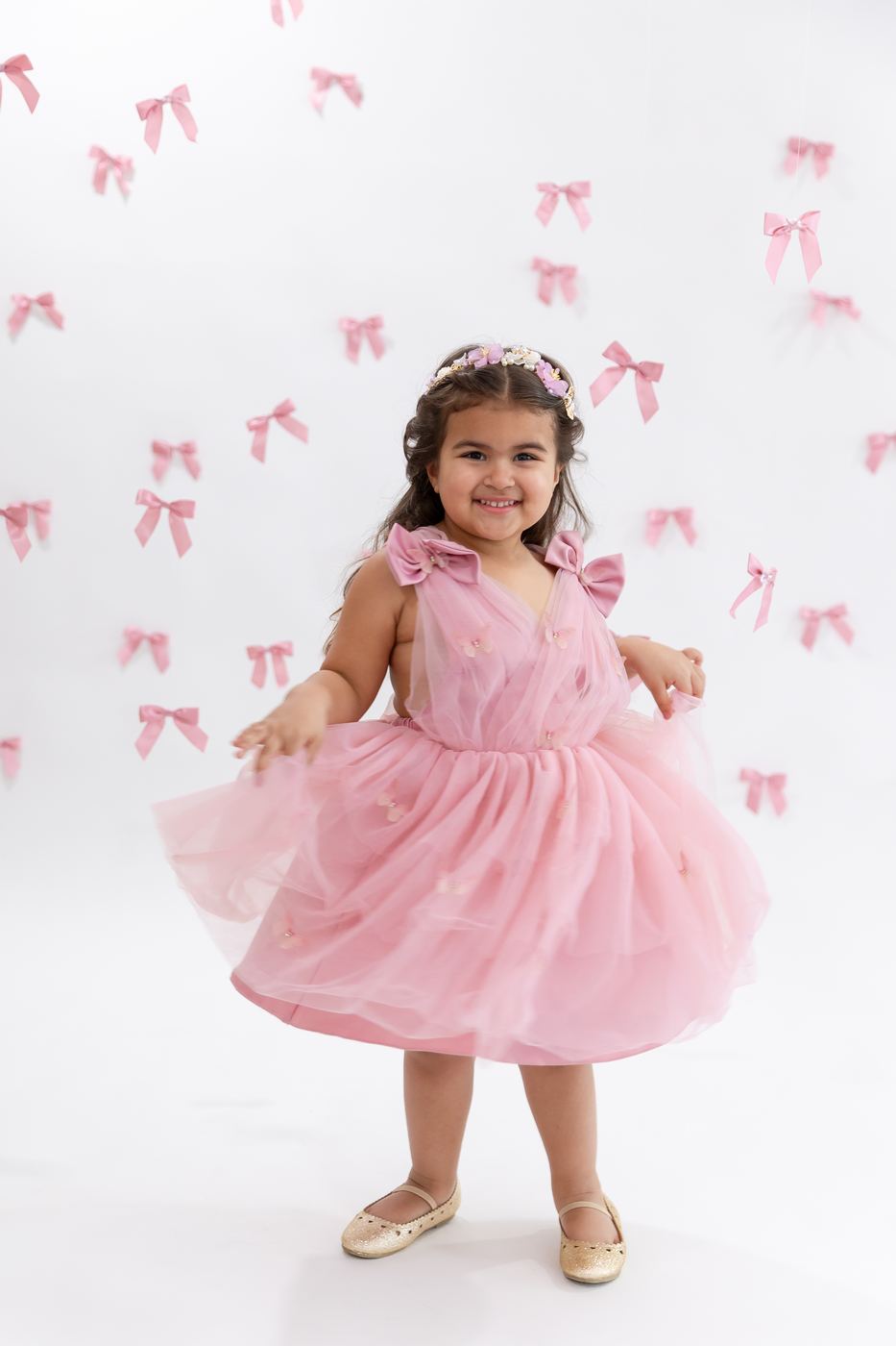 Little girl in a pink tulle dress with bows at a birthday mini session, Cape Coral FL