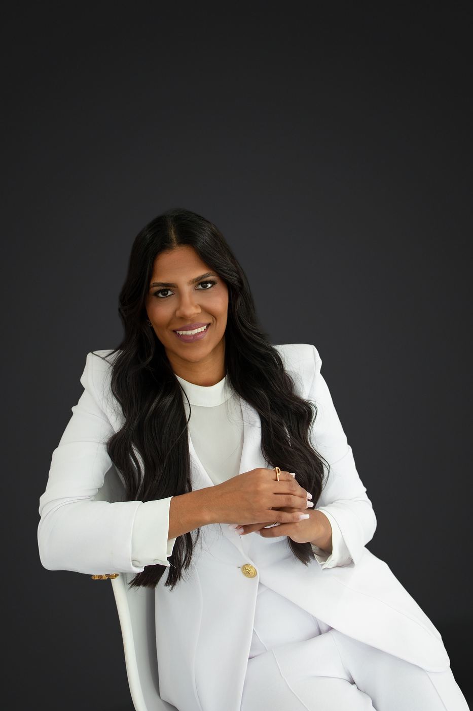 Confident branding portrait in a white blazer on a dark backdrop, Cape Coral headshot photographer